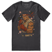 Black t-shirt with a graphic of a muscular character holding a sword, surrounded by cherry blossoms, on a white background.