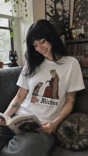 Sir Michus Cat T-Shirt customer wearing the white shirt while reading manga with her cat