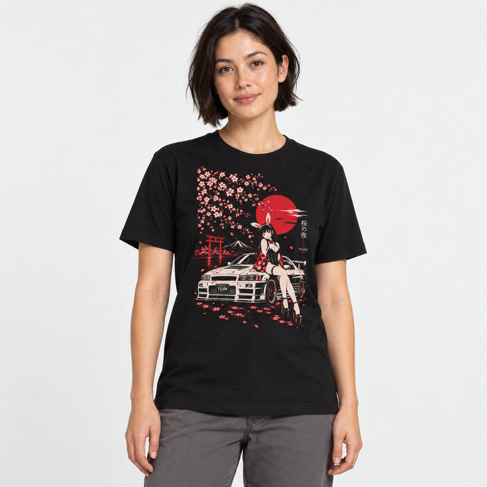 Female model wearing the Sakura Night Car T-Shirt in Black, showing the cherry blossom, red moon and car artwork