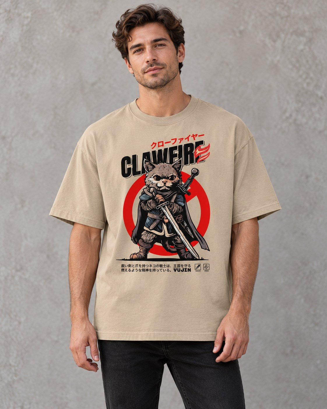 Male model wearing the khaki Clawfire oversized faded cat T-shirt against a gray wall