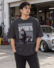 Hashiriya oversized faded black car T-shirt worn outside a garage beside a classic car