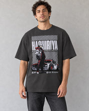 Male model wearing the Hashiriya oversized faded black car T-shirt against a gray wall